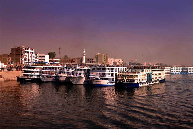 River cruise ships anchored on the Nile at Edfu, Egypt &mdash; Nile river cruise